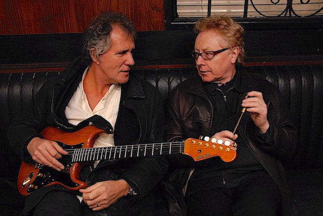 John Illsley holding a Blade Levinson Strat & Paul Brady